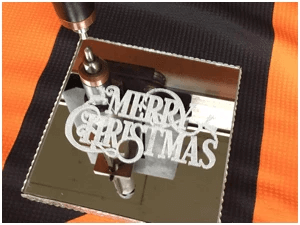 Merry Christmas logo scribed into a mirror