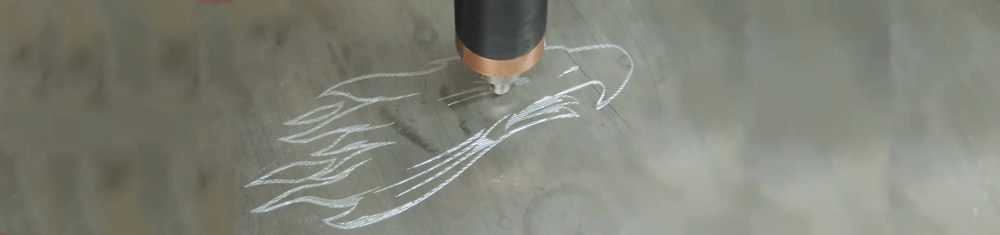 Screaming eagle logo being scribed in stainless steel.